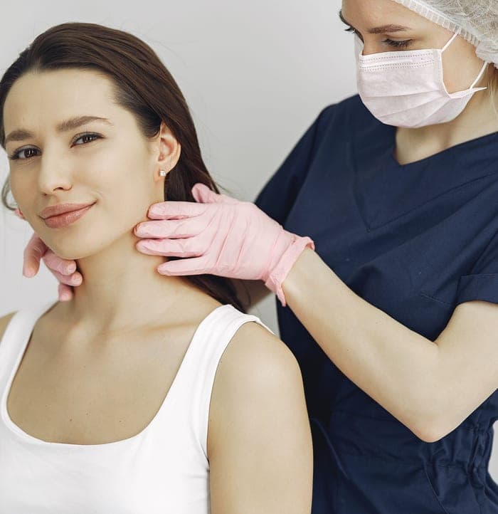 Dermatologist examining a smiling patient