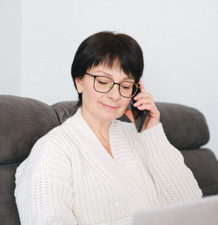 Older woman booking an appointment by phone