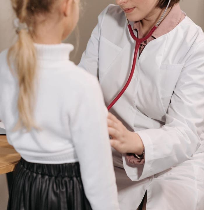 Pediatrician listening to a child's heartbeat