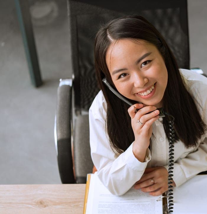 Receptionist smiling while answering a patient's call